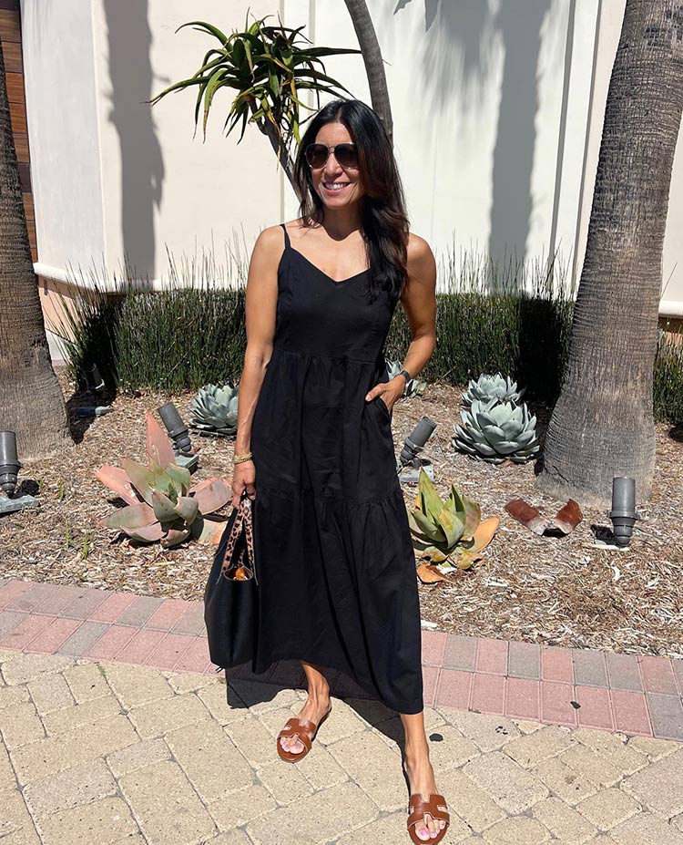 Adaline in a black maxi dress and slide sandals | 40plusstyle.com