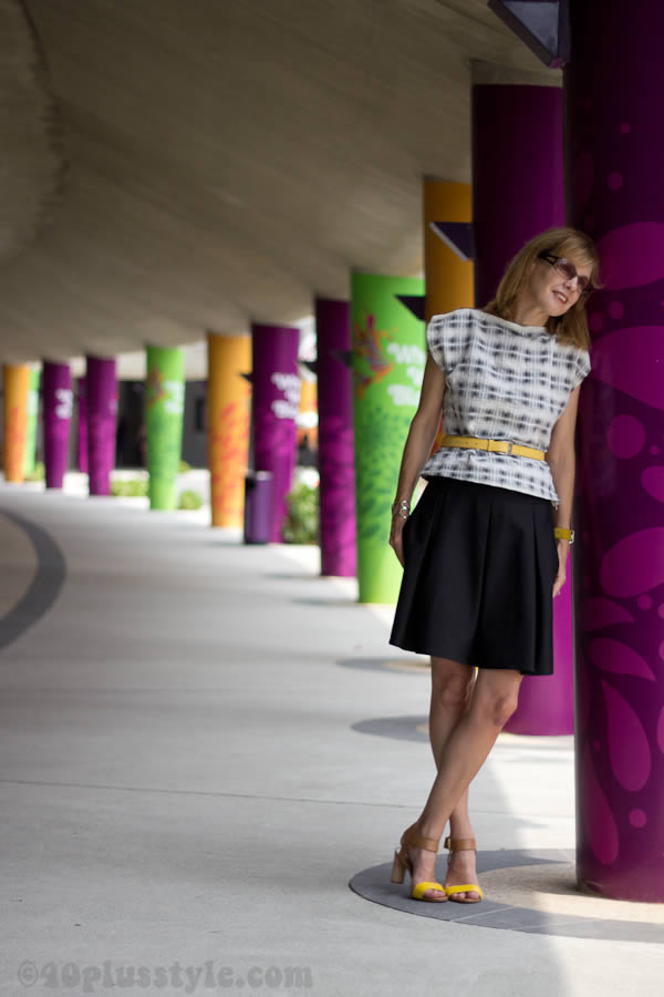 Black a-line skirt with a printed top and yellow shoes | 40plusstyle.com