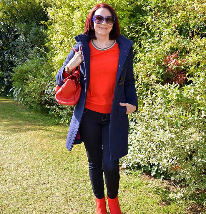 Emma wears a red sweater and booties | 40plusstyle.com