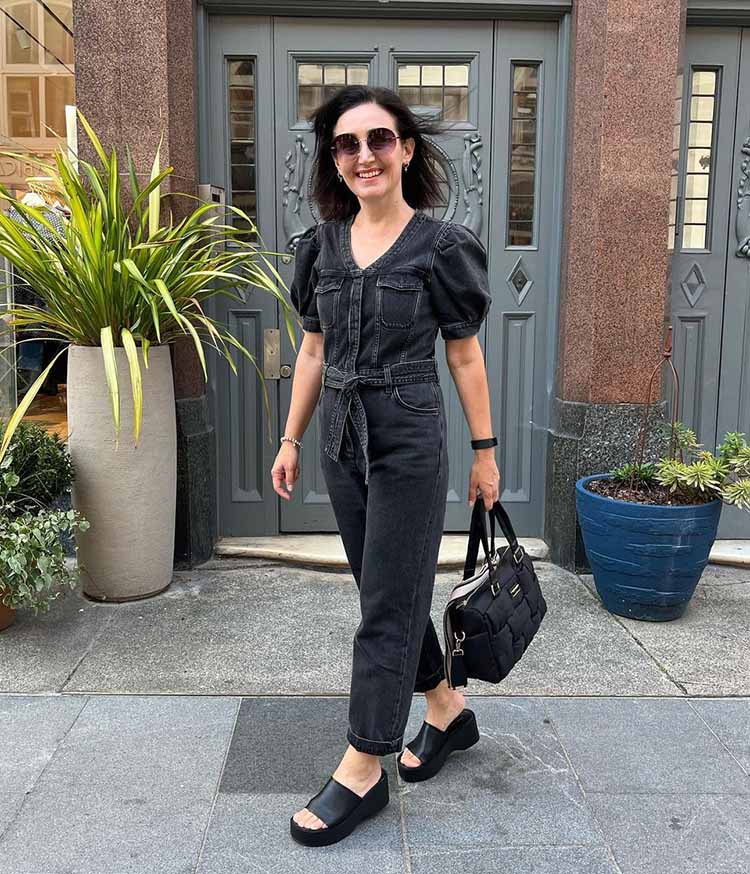 Emms wears a denim jumpsuit | 40plusstyle.com