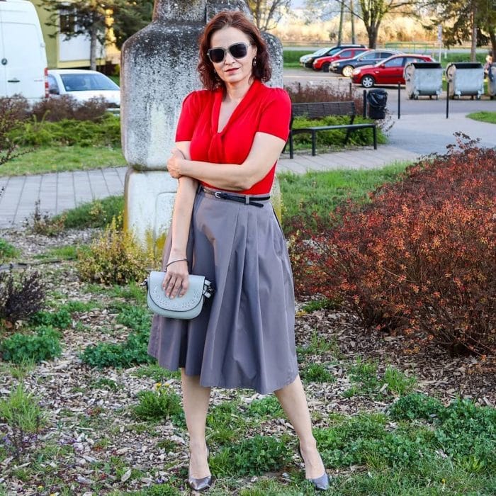 Erika wears a red blouse and gray skirt | 40plusstyle.com