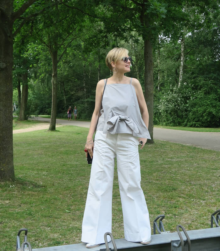 Sylvia wearing white flared pants | 40plusstyle.com