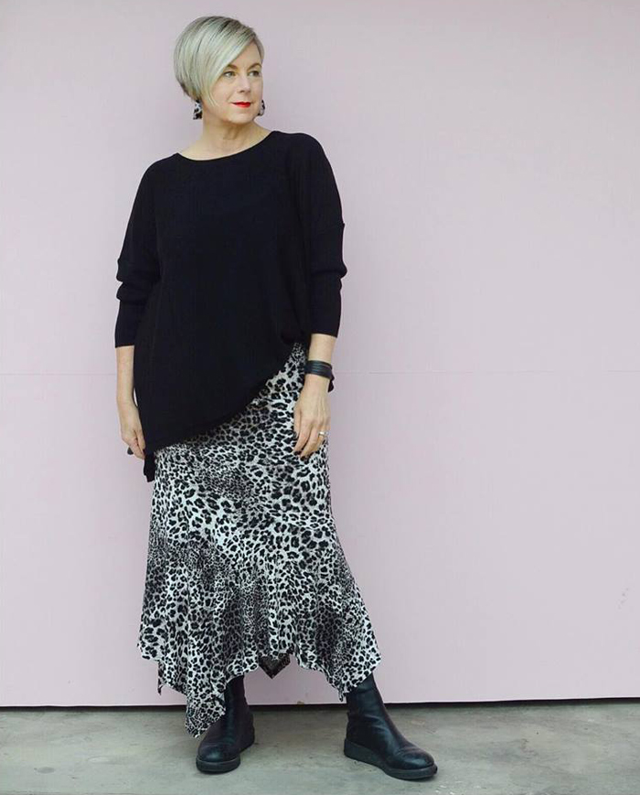 Deborah wearing black sweater and printed skirt | 40plusstyle.com