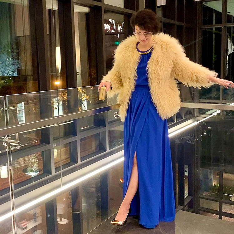 Natalia wears a blue dress and faux fur jacket | 40plusstyle.com