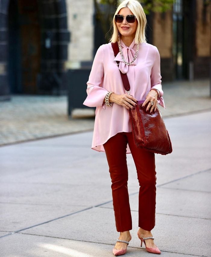 Petra wears burgundy pants and a pink blouse | 40plusstyle.com