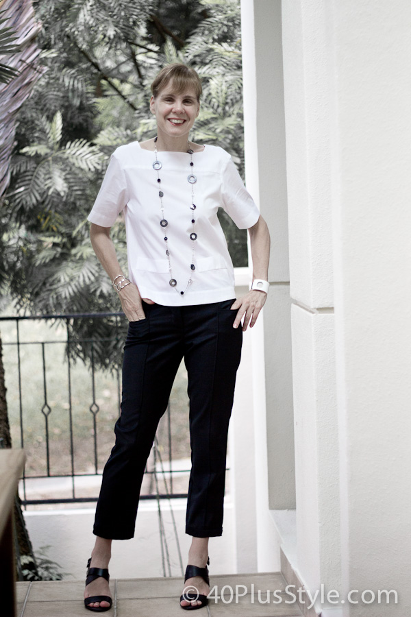 Black pants with white top and a statement necklace - a classic combination | 40plusstyle.com